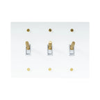 Close-up of knurled toggle detail on white 3-gang switch plate
