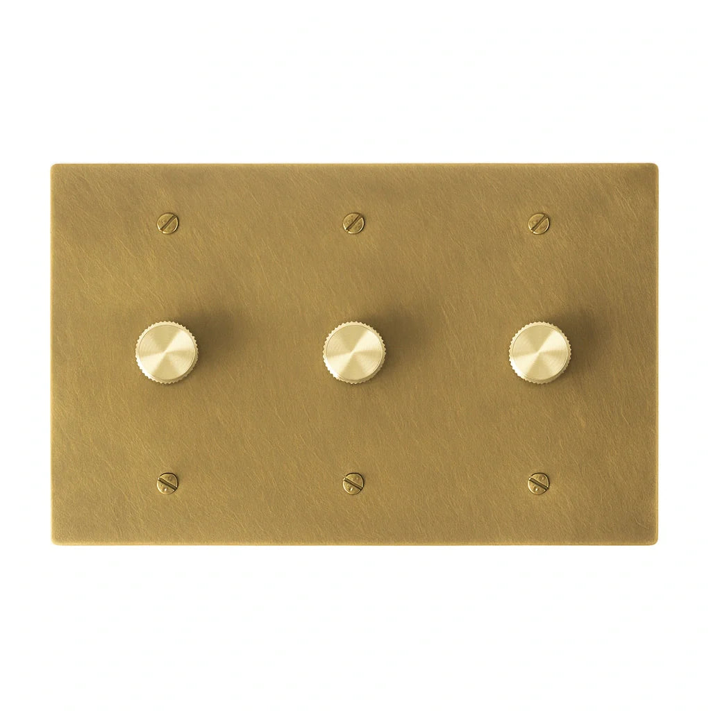 Three gang antique brushed brass dimmer switch with smooth brass control knobs and vintage finish.