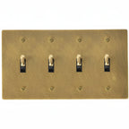4-gang knurled toggle light switch plate in antique brass, hand-brushed, front view