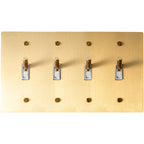 Close-up of knurled toggle levers on satin brass 4-gang switch plate