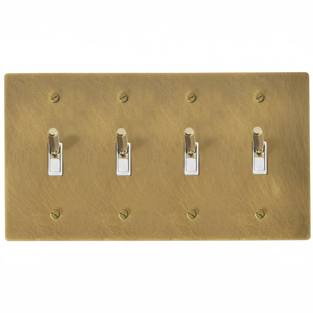Close-up of knurled toggle detail on antique brass 4-gang switch plate