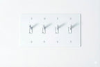 4-gang knurled toggle light switch plate in white, front view