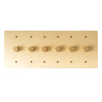 6 gang brass dimmer wall plate with evenly spaced rotary knobs and warm satin finish.