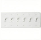 6-gang knurled toggle light switch plate in white, front view