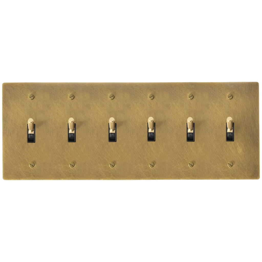 6-gang knurled toggle light switch plate in antique brass, hand-brushed, front view