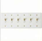 Close-up of knurled toggle detail on white 6-gang switch plate