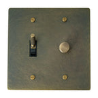 Decorative wall switch plate with brass screws on a white background