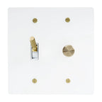 White light switch plate with gold knobs on a white background