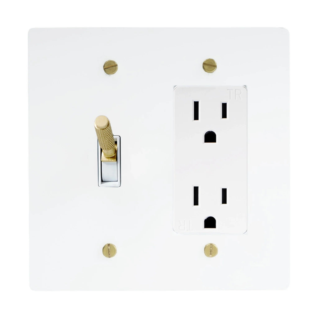 White light switch and outlet cover with gold screws on a white background